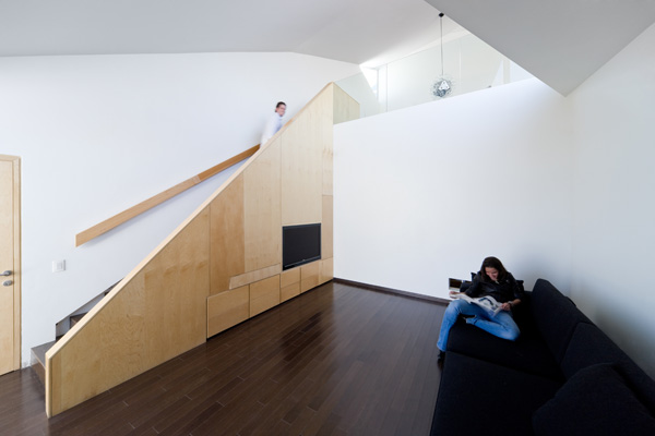 Το καθιστικό της τηλεόρασης. Η θέση της στην πλαϊνή πλευρά της σκάλας μέσα στην ξύλινη επένδυση κρίνεται ευρηματική  Το καθιστικό της τηλεόρασης. Η θέση της στην πλαϊνή πλευρά της σκάλας μέσα στην ξύλινη επένδυση κρίνεται ευρηματική