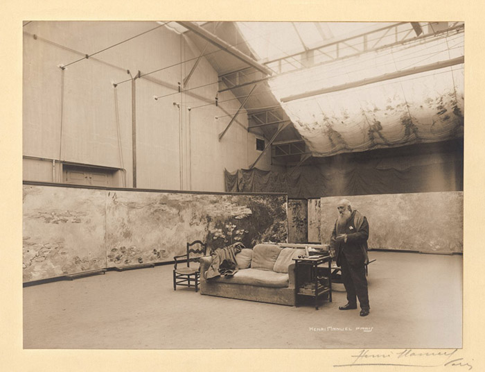 Henri Manuel Claude Monet in front of his paintings The Waterlilies in his studio